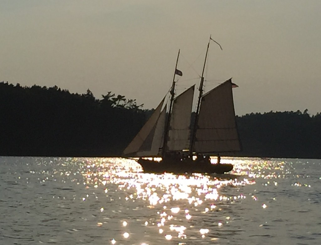 The Schooner Lazy Jack sailing on Boothbay Harbor in the late afternoon sun.